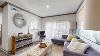 Located at 7009 Almeda Rd in Houston, TX, this thoughtfully designed single-story residence offers one bedroom and three bathrooms within a compact yet efficiently utilized floor plan. The living room serves as the heart of the home, featuring wood-look flooring, crown molding with gray accents, and a sliding glass door fitted with vertical blinds that floods the space with natural light. The kitchen is equipped with stainless steel appliances, including a Whirlpool range and refrigerator, complemented by gray cabinetry, white countertops, and a window that brings in additional natural light. The bedroom provides a comfortable retreat with a ceiling fan, teal drapery, and access to a dedicated walk-in closet outfitted with wire shelving. The primary bathroom features an extended vanity with a large mirror, a soaking tub with shower, and the same wood-look flooring found throughout the unit. Three bathrooms in total offer ample convenience. Crisp white walls and consistent flooring tie the space together, creating a cohesive, modern aesthetic throughout this well-organized Houston residence.