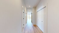 Located in Chicago's vibrant West Loop neighborhood, this modern 2-bedroom, 2-bathroom residence showcases contemporary design throughout. Light-toned hardwood flooring flows seamlessly across the open layout, complemented by crisp white walls and recessed lighting that create a clean, airy ambiance. The kitchen features wood-grain cabinetry, white quartz countertops, a textured tile backsplash, a gas range, and matte black fixtures, with a glass door opening directly to a private balcony overlooking lush treetops and the iconic Chicago skyline. Both bedrooms are generously proportioned with large windows that flood the rooms with natural light; the primary bedroom offers direct balcony access and city views, while the second bedroom includes a built-in closet. The two bathrooms are finished in a consistent modern palette, with wood-tone vanities, matte black hardware, and large-format tile. One bathroom features a sleek walk-in glass shower. Additional highlights include multiple private balconies accessible from the building's exterior corridor, offering panoramic views of the Chicago skyline and surrounding neighborhood — an exceptional feature that enhances the urban living experience of this well-appointed residence.