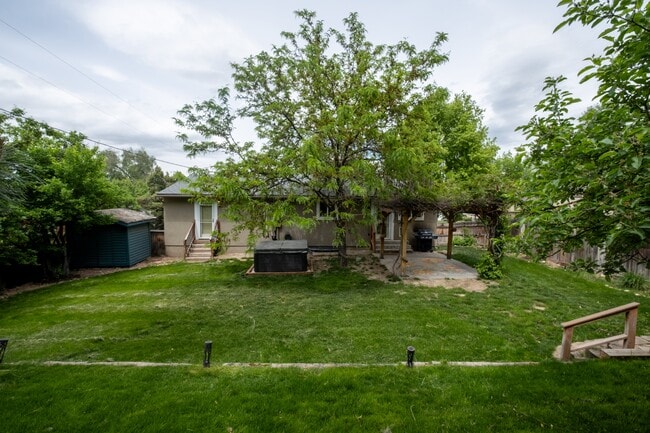 Backyard view of house, shed and hot tub - 1544 E 8640 S