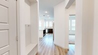 This well-appointed 2-bedroom, 3-bathroom residence in Waco, Texas offers a thoughtfully designed single-floor layout with a clean, modern aesthetic throughout. The open-concept kitchen serves as the heart of the home, showcasing rich dark cabinetry, granite countertops, a subway tile backsplash, and a full suite of stainless steel appliances including a refrigerator, range, microwave, and dishwasher. A central island with pendant lighting adds both function and style, while large windows flood the space with natural light. Light-toned wood-look flooring runs throughout the main living areas, creating a warm and cohesive feel. The hallway entry features a built-in bench and wall hooks, offering a practical drop zone. Both bedrooms are carpeted and well-lit, each equipped with a ceiling fan and sizable windows dressed with blinds. The primary bedroom connects to a private bathroom featuring dark cabinetry, a granite vanity, built-in shelving, and direct access to a closet. Additional bathrooms include a tub-shower combination with elegant marble-style tile surround and granite vanity. The overall design balances contemporary finishes with functional living spaces.