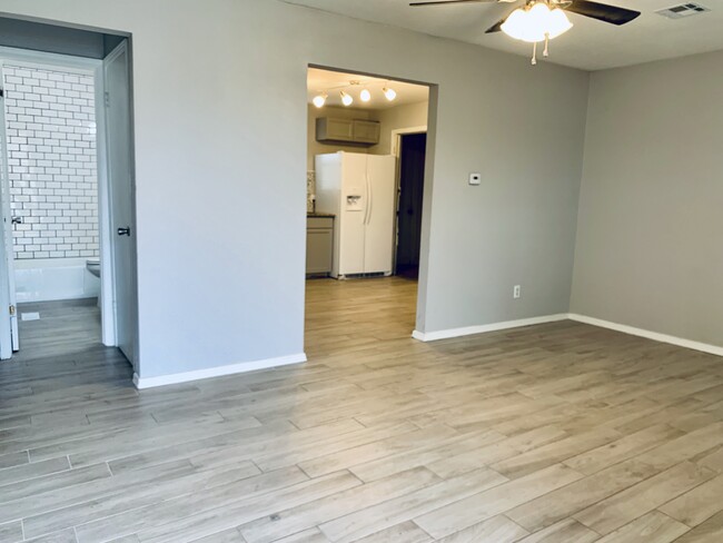 Grey living room with beautiful grey porcelain wood plank tile. - 104 E Knoxville St