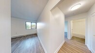Located at 401 West St N in Orillia, Ontario, this 2-bedroom, 1-bathroom unit offers a clean, modern aesthetic across a thoughtfully designed single-floor layout. Light wood laminate flooring runs throughout the space, contributing to a warm and cohesive feel in every room.

The living room is a comfortable, open area with crisp white walls, a flush ceiling light, and direct sightlines to the kitchen, making it ideal for everyday living. Large windows in the living and bedroom areas invite natural light and offer views of the surrounding greenery.

The galley-style kitchen is efficiently designed with white shaker cabinetry, dark countertops, a subway tile backsplash, stainless steel appliances including a fridge and stove, and a double sink — providing both style and practicality.

The generously sized primary bedroom features a sliding-door closet, baseboard heating, and a window with outdoor views. The second bedroom is equally bright, with its own window and light-filled atmosphere. Both rooms are finished with the same light wood flooring found throughout.

The bathroom is finished with classic white subway tile surrounding the tub-shower combination, chrome fixtures, and a clean, timeless look. The unit also includes a hallway, entrance area, and a dedicated closet, completing a practical and well-organized floor plan.