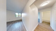 Located at 401 West St N in Orillia, Ontario, this 2-bedroom, 1-bathroom unit offers a clean, modern aesthetic across a thoughtfully designed single-floor layout. Light wood laminate flooring runs throughout the space, contributing to a warm and cohesive feel in every room.

The living room is a comfortable, open area with crisp white walls, a flush ceiling light, and direct sightlines to the kitchen, making it ideal for everyday living. Large windows in the living and bedroom areas invite natural light and offer views of the surrounding greenery.

The galley-style kitchen is efficiently designed with white shaker cabinetry, dark countertops, a subway tile backsplash, stainless steel appliances including a fridge and stove, and a double sink — providing both style and practicality.

The generously sized primary bedroom features a sliding-door closet, baseboard heating, and a window with outdoor views. The second bedroom is equally bright, with its own window and light-filled atmosphere. Both rooms are finished with the same light wood flooring found throughout.

The bathroom is finished with classic white subway tile surrounding the tub-shower combination, chrome fixtures, and a clean, timeless look. The unit also includes a hallway, entrance area, and a dedicated closet, completing a practical and well-organized floor plan.