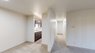Located at 2415 Springdale Rd in Waukesha, WI, this single-floor residence offers a well-organized layout featuring two bedrooms, two bathrooms, a kitchen, pantry, closet, and a connecting hallway. The open living area is carpeted and bathed in natural light from a large sliding glass door that frames views of the surrounding greenery, with baseboard heating running along the walls. The galley-style kitchen is efficiently designed with dark cabinetry, white countertops, a stainless steel double sink, wood-look flooring, and white appliances including a refrigerator and range, with a pantry conveniently tucked at the rear. The spacious primary bedroom features plush carpeting, a natural light-filled window, baseboard heating, and a wide double-door closet. The second bedroom is similarly carpeted and bright, with a window overlooking the exterior. Both bathrooms are clean and functional — one features a tub/shower combination with a white surround, while the other offers a vanity with white cabinetry, a large mirror, and a tiled shower. The hallway connects all rooms with ease, creating a cohesive and practical flow throughout the home.