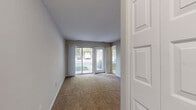 Located at 14120 Weeping Willow Dr in Silver Spring, MD, this one-bedroom, one-bathroom residence is thoughtfully laid out across a single floor, offering a well-organized and functional living space. The entrance leads into a hallway that connects the key areas of the home seamlessly.

The living room is carpeted and bathed in natural light, featuring a sliding glass door that opens to an outdoor view of lush greenery — a standout feature that brings the outdoors in. A pendant light fixture adds a subtle decorative touch to this open, airy space.

The kitchen is equipped with warm honey-toned wood cabinetry, dark countertops, and black appliances including a gas range and refrigerator. Light wood-style flooring completes the practical yet inviting kitchen aesthetic. A window with vertical blinds allows additional natural light into the space.

The bedroom is generously proportioned, featuring soft carpeting, a window with a green outdoor view, and a large double-door closet providing ample storage. The neutral wall tones create a calm and restful atmosphere.

The bathroom features tile flooring, a tiled tub-shower combination, a white vanity with sink, and overhead lighting, offering a clean and functional design. The overall color palette throughout the home is neutral and bright, lending a cohesive and welcoming ambiance.