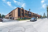 Located at 17830 Sherman Way, Unit #313 in Reseda, California, this single-floor residence presents a clean, modern aesthetic highlighted by light-toned hardwood-style flooring that runs seamlessly throughout the entire unit. The open-concept living area is a standout feature, bathed in natural light courtesy of a full-height sliding glass door fitted with vertical blinds, and complemented by a ceiling fan overhead. The layout flows naturally between the living space and the kitchen, which has been thoughtfully updated with crisp white shaker cabinetry, granite-style countertops, a stainless steel double-basin sink, a stainless steel dishwasher, and a stainless steel gas range with an overhead ventilation hood — offering both style and functionality. The bedroom is generously proportioned, featuring a wide sliding-door closet, neutral white walls, and its own access to natural light. The bathroom is finished with consistent granite-style countertops on the vanity and continued hardwood-style flooring, maintaining a cohesive design language throughout the unit. Textured ceilings add subtle architectural character, while the bright white walls and abundant natural light create a clean, airy ambiance throughout this well-appointed Reseda residence.
