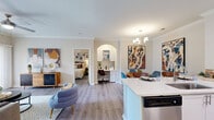 Located at 1310 Silver Sage Dr in Raleigh, NC, this well-appointed 2-bedroom, 2-bathroom single-floor residence offers a thoughtfully designed layout with modern finishes throughout. Wood-look plank flooring flows seamlessly across the living spaces, complemented by crown molding that adds a refined touch.

The open-concept kitchen is a standout feature, showcasing white shaker cabinetry, a white quartz peninsula with bar seating, a subway tile backsplash, and a full suite of stainless steel appliances. The adjacent dining area benefits from an elegant chandelier, creating an inviting atmosphere for meals and gatherings. The living room opens directly to a private balcony through sliding glass doors, allowing for natural light and outdoor access.

Both bedrooms are generously sized, featuring large windows with blinds and curtains that provide ample natural light and privacy. Ceiling fans add comfort, and each bedroom includes closet storage. The two bathrooms are finished with white vanities, quartz countertops, and tiled shower-tub combinations. A dedicated in-unit laundry room houses a full-size washer and dryer with overhead shelving for added convenience. Two closets throughout the home offer practical storage solutions, completing this functional and stylish Raleigh residence.
