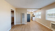 Located in Arden-Arcade, Sacramento, this compact and efficiently designed 2-bedroom, 1-bathroom unit offers a thoughtful layout across a single floor. Light oak-toned laminate flooring runs throughout, creating a warm, cohesive feel from room to room.

The kitchen is smartly appointed with white cabinetry, granite-style countertops, and stainless steel appliances including a full-size refrigerator, gas range, and dishwasher. A ceiling fan with integrated lighting brightens the space, while a window allows for natural light.

The primary bedroom features striking vaulted ceilings that add a sense of openness beyond what the footprint might suggest, along with a window overlooking the surrounding neighborhood. The second bedroom is equally bright, with natural light filtering through the windows and casting soft shadows across the neutral walls.

The bathroom retains a classic charm with its hexagonal black-and-white mosaic tile flooring, a wall-mounted sink, and a vanity light fixture above the mirror, delivering a clean and timeless aesthetic.

Two hallways connect the rooms, offering practical flow throughout the unit. The consistent warm beige tones and white trim throughout give the space a clean, move-in-ready appearance well-suited for comfortable everyday living.