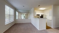 This one-bedroom, one-bathroom residence in Duluth, GA offers a well-designed single-floor layout that balances comfort and functionality. The open-concept living and dining area is generously sized, featuring plush carpet flooring, crown molding, a ceiling fan, and multiple windows that fill the space with natural light and provide views of the surrounding greenery. A large wall mirror in the living area further enhances the sense of openness.

The kitchen is thoughtfully appointed with white shaker-style cabinetry, granite countertops, wood-look flooring, and a full suite of stainless steel appliances including a refrigerator, electric range with overhead vent, and dishwasher. A breakfast bar peninsula connects the kitchen to the living area, making it ideal for casual dining or entertaining.

The bedroom is a comfortable retreat with soft carpet, a ceiling fan, and windows offering natural light. It connects directly to a walk-in closet and a private bathroom. The bathroom features wood-look flooring, white cabinetry, a granite vanity countertop, and a clean, neutral palette throughout.

A hallway provides easy access to all areas of the unit, contributing to the overall efficient and practical flow of the floor plan.
