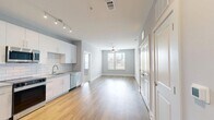Located at 940 E Adams St in Jacksonville, FL, this well-appointed 2-bedroom, 2-bathroom residence offers a thoughtfully designed single-floor layout with a clean, modern aesthetic throughout. The open kitchen is a standout feature, showcasing white shaker-style cabinetry, granite countertops, a classic white subway tile backsplash, and a full suite of stainless steel appliances including a refrigerator, range, microwave, and dishwasher. Warm-toned hardwood-style flooring runs through the kitchen and living areas, creating a cohesive, contemporary feel. Both bedrooms are carpeted for comfort, painted in soft gray tones, and equipped with ceiling fans and window blinds that allow for natural light and outdoor views. The primary bedroom offers a generous footprint with ample room to furnish. Each bathroom continues the modern design language with white floating vanities, granite countertops, and glass-enclosed showers, complemented by the same hardwood-style flooring seen in the main living areas. Two closets provide convenient storage throughout the home. The unit also includes two dedicated closets, rounding out a practical and stylish living space in the heart of Jacksonville.