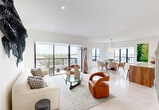 This elegant 1,420 square foot condo in Coral Gables offers a harmonious blend of modern design and practical living. The open-concept floor plan seamlessly integrates the living, dining, and kitchen areas, creating a spacious and airy atmosphere. Large windows throughout allow abundant natural light and provide scenic views of the surrounding area.

The kitchen is a chef's dream, featuring sleek cabinetry, high-end appliances, and ample counter space. The living room is adorned with contemporary art pieces and stylish furniture, including a comfortable sofa and a unique glass coffee table. The dining area boasts a round glass table with plush chairs, perfect for intimate gatherings or family meals.

The primary bedroom, spanning 210 square feet, is a serene retreat with a large bed, modern lighting fixtures, and access to a private balcony. The bathrooms are elegantly appointed with floating vanities, large mirrors, and glass-enclosed showers.

Throughout the condo, you'll find thoughtful design elements such as built-in closets, minimalist decor, and a neutral color palette that enhances the sense of space. The property also includes a dedicated workspace with custom shelving and a stylish desk, ideal for remote work or study.

With its prime location in Coral Gables and its sophisticated interior, this condo offers a perfect blend of urban living and modern comfort.