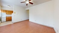 This one-bedroom, one-bathroom unit at 910 Portland Avenue in Minneapolis, MN offers an efficiently designed layout across a single floor. The space flows from a hallway entry into the main living area, which features warm wood-look flooring, neutral white walls, and a ceiling fan with integrated lighting. Baseboard heating units are present throughout, providing consistent warmth during Minnesota winters.

The spacious primary bedroom occupies a generous portion of the unit, offering ample room for furnishings. It includes wood-look flooring consistent with the rest of the unit, along with baseboard heating and a dedicated closet for storage.

The kitchen is well-appointed with warm honey-toned wood cabinetry extending to the upper walls, providing substantial storage. It includes a white electric range, refrigerator, and a window that allows natural light into the space. The tile-style flooring is practical and easy to maintain.

The bathroom features a full tub-shower combination, a toilet, and a vanity with matching warm wood cabinetry and a light countertop. Tile-style flooring completes the functional space.

Overall, the unit presents a clean, straightforward layout well-suited for those seeking practical, comfortable living in the Portland Avenue corridor of Minneapolis.