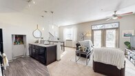 Located at 601 W Bacon St in Richmond, Virginia, this two-story residence offers four bedrooms and four bathrooms spread across a well-designed layout. The main floor opens into a seamless combination of living, dining, and kitchen spaces, creating a sociable and functional hub for daily life. The kitchen is outfitted with dark espresso cabinetry, granite-style countertops, a double sink, and black appliances including a range, microwave, and refrigerator. A built-in pantry nook with shelving adds practical storage. The living area is bright and welcoming, featuring large windows, French doors that invite natural light, and a ceiling fan overhead. Soft carpet runs throughout the living space, adding warmth and comfort. Upstairs, four well-proportioned bedrooms each offer ample natural light through broad windows, plush carpeting, and closet storage. The primary bedroom features its own ceiling fan and a dedicated closet. Four full bathrooms include tub-shower combinations, providing convenience for all occupants. A dedicated laundry area and two staircases round out the floor plan. The neutral color palette and clean finishes throughout give the space a modern, move-in-ready feel.