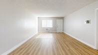 Located in Santa Ana, CA, this well-appointed 1-bedroom, 2-bathroom residence offers a clean, modern aesthetic throughout its efficiently designed single-floor layout. Wood-style plank flooring flows seamlessly through every room, complemented by neutral gray walls and crisp white trim, creating a cohesive and inviting atmosphere.

The open living area is generously sized, bathed in natural light through vertical-blind-covered windows and a sliding glass door fitted with a ceiling fan overhead. The layout connects naturally to the kitchen, which is a standout feature — fully equipped with stainless steel appliances including a refrigerator, range, microwave, and dishwasher, all set against granite-style countertops and tall white shaker cabinets with modern hardware.

The primary bedroom is comfortably proportioned, with a large window allowing ample natural light and access to a dedicated closet. Both bathrooms mirror the home's modern design language, featuring white vanity cabinetry, granite-style countertops, mosaic tile accents, and wood-style flooring. One bathroom includes a full tub/shower combination. Textured ceilings are present throughout, adding a classic residential character to this thoughtfully updated space.