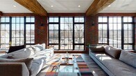 Located at 270 Waverly Ave in Mamaroneck, NY, this single-floor amenity space blends industrial character with modern comfort. Exposed brick walls, steel-framed windows, and reclaimed wood ceiling beams establish a warm, loft-inspired aesthetic throughout.

The fitness center is a standout feature, outfitted with multiple treadmills, elliptical machines, a stationary bike, strength training equipment, and a full rack of dumbbells and medicine balls. Large windows flood the space with natural light and offer views of the surrounding neighborhood, while floor-to-ceiling mirrors enhance the sense of openness. Industrial ductwork adds to the raw, architectural appeal.

The social lounge provides a sophisticated gathering space with plush seating, a billiards table, a wall-mounted fireplace framed in rich dark paneling, and a communal dining table beneath striking circular pendant lights. Steel-framed glass doors lead to an outdoor terrace furnished with lounge seating.

A dedicated wet bar features draft beer taps, a deep farmhouse sink, light wood cabinetry, open shelving, and a subway tile backsplash—ideal for entertaining. A vibrant children's playroom with climbing structures and a soft patterned carpet rounds out this well-appointed amenity level.