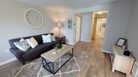 Located at 8504 82nd St in Tacoma, Washington, this single-floor home offers a clean, contemporary interior with a welcoming and functional layout. The living area serves as the heart of the home, showcasing warm hardwood-style flooring that flows seamlessly throughout the space. Neutral gray walls create a calm, versatile backdrop that complements a variety of décor styles. A well-proportioned hallway leads from the main living area toward the rest of the home, providing a clear and organized sense of flow between rooms. The interior is finished with modern flush-mount lighting, crisp white trim, and solid interior doors that contribute to the home's polished, move-in-ready appearance. The open sightlines between the living space and hallway enhance the sense of connectivity throughout the floor plan. Overall, the home presents a bright, tidy, and well-maintained interior, with consistent flooring and neutral tones that create a cohesive and inviting atmosphere from room to room. This Tacoma property combines practical design with modern aesthetics, making it a comfortable and stylish single-level home.