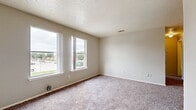 Located at 4500 Campus Dr in Fort Worth, TX, this one-bedroom, one-bathroom unit offers a practical and efficiently arranged floor plan across a single level. The kitchen is a standout feature, outfitted with white cabinetry, white countertops, a tile backsplash, and black appliances including a refrigerator, electric range, and dishwasher. Wood-look flooring runs throughout the kitchen, providing a clean and durable surface that transitions into the carpeted living areas. The bedroom is a comfortably sized retreat, featuring plush wall-to-wall carpet, neutral gray walls, and a textured ceiling. It includes direct access to a dedicated closet as well as the full bathroom, adding convenience to the layout. The bathroom is clean and straightforward, featuring a full tub-shower combo with white tile surround and standard fixtures. Neutral tones are carried throughout the unit, creating a cohesive and understated aesthetic. The overall layout is compact yet functional, making efficient use of the available space. This unit is well-suited for individuals or couples seeking a manageable, low-maintenance living space in Fort Worth, Texas.