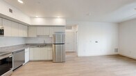 Located at 9275 North 29th Avenue in Phoenix, AZ, this well-designed one-bedroom, one-bathroom unit offers a clean, modern aesthetic throughout its single-floor layout. Light wood-style flooring flows continuously through every room, creating a cohesive and airy feel.

The open-concept kitchen and living area forms the heart of the unit. The kitchen is equipped with a full suite of stainless steel appliances — including a refrigerator, range, microwave, and dishwasher — paired with white cabinetry that extends to the ceiling for ample storage, and granite-style countertops with an integrated sink. Recessed lighting illuminates the kitchen, while the adjacent living area benefits from a ceiling fan and a window overlooking the surrounding neighborhood.

The bedroom is a well-proportioned retreat featuring a ceiling fan, a window with views of palm trees and the Phoenix streetscape, and direct access to a generously sized walk-in closet outfitted with dual clothing rods and shelving on multiple walls.

The bathroom is clean and contemporary, showcasing a granite-top vanity with an undermount sink, a large walk-in shower enclosed by sliding glass doors, and matching wood-style flooring. A hallway connects the main living areas, completing this efficiently arranged and move-in-ready home.