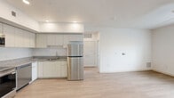 Located at 9275 North 29th Avenue in Phoenix, AZ, this well-designed one-bedroom, one-bathroom unit offers a clean, modern aesthetic throughout its single-floor layout. Light wood-style flooring flows continuously through every room, creating a cohesive and airy feel.

The open-concept kitchen and living area forms the heart of the unit. The kitchen is equipped with a full suite of stainless steel appliances — including a refrigerator, range, microwave, and dishwasher — paired with white cabinetry that extends to the ceiling for ample storage, and granite-style countertops with an integrated sink. Recessed lighting illuminates the kitchen, while the adjacent living area benefits from a ceiling fan and a window overlooking the surrounding neighborhood.

The bedroom is a well-proportioned retreat featuring a ceiling fan, a window with views of palm trees and the Phoenix streetscape, and direct access to a generously sized walk-in closet outfitted with dual clothing rods and shelving on multiple walls.

The bathroom is clean and contemporary, showcasing a granite-top vanity with an undermount sink, a large walk-in shower enclosed by sliding glass doors, and matching wood-style flooring. A hallway connects the main living areas, completing this efficiently arranged and move-in-ready home.