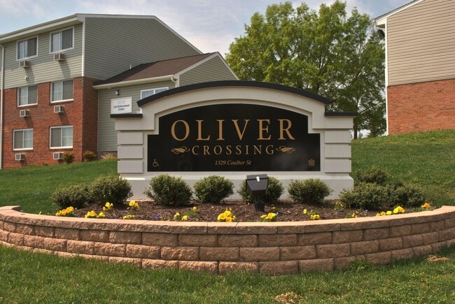 Oliver Crossing apartment community entrance sign with professionally landscaped grounds - Oliver Crossing