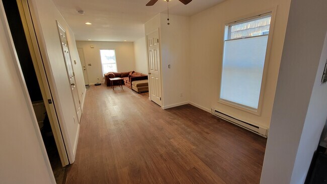 Dining and Living Rooms from Kitchen. Half-Bath through pocket door. - 46 Summitt Ave
