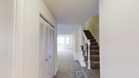 Located at 3287 Lauriston Pl in Fairfax, VA, this two-story home offers a well-organized layout across two floors, providing comfortable living space for its residents. The main floor hosts the living room, kitchen, a hallway, and a bathroom, while the upper floor contains the two bedrooms and additional bathrooms.

The living room is bright and inviting, featuring plush carpeting, neutral walls, and large windows that allow abundant natural light to fill the room. A white-railed staircase with carpeted treads connects the two floors, and a louvered bifold closet door in the hallway provides convenient storage.

The kitchen is clean and functional, finished with light wood-style flooring, white cabinetry, and ample counter space. A window above the sink brings in natural light, while a stacked washer and dryer unit is neatly integrated into the kitchen area for added convenience. White appliances, including a refrigerator and dishwasher, complete the space.

Upstairs, the generously sized primary bedroom features carpet flooring, a window with an outdoor view, and a full-width louvered closet. The second bedroom also offers carpet flooring and bright, neutral walls. All three bathrooms are clean and simply appointed, with white fixtures and tub/shower combinations in the full baths.