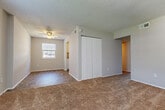 Located at 3605 Kecoughtan Rd in Hampton, Virginia, this single-story, 3-bedroom, 1-bathroom home offers a functional and straightforward layout designed for comfortable everyday living. The living area welcomes you with a combination of tile and plush carpet flooring, a ceiling fan, and a large window that allows natural light to fill the space. A front entry door is flanked by a sizable window, creating a bright and open feel near the main entrance. The kitchen features white cabinetry, tile flooring, and includes a range with an overhead ventilation hood, providing a practical cooking space. Three carpeted bedrooms offer quiet retreats, each with neutral-toned walls and adequate closet space — the primary bedroom includes a double sliding-door closet and a ceiling fan. Additional bedrooms feature their own closets with easy hallway access. Textured ceilings are consistent throughout the home. The full bathroom is finished with tile flooring and includes a tub/shower combination with white tile surround, a toilet, and a vanity. A central hallway connects the bedrooms and bathroom efficiently. The overall aesthetic is clean, neutral, and move-in ready, making this Hampton home a practical choice.