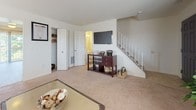 Located at 55 Insley Way in Nottingham, Maryland, this two-story residence offers a well-organized layout designed for comfortable everyday living. The main level features a bright living room with a bay window that allows natural light to fill the carpeted space. Adjacent to the living room, the dining area opens directly onto a private balcony through sliding glass doors, offering pleasant views of surrounding trees—an ideal setting for relaxed indoor-outdoor living.

The kitchen is efficiently designed with warm oak cabinetry, generous counter space, and white appliances including a dishwasher, range, and built-in microwave. A dedicated laundry room with a full-size washer and dryer, tile flooring, and overhead shelving adds valuable convenience.

A staircase leads to the upper level, where multiple bedrooms provide comfortable retreats. Each bedroom features plush carpeting and closet storage, with the primary bedroom benefiting from natural light through a large window. The full bathroom on this level includes a tub-shower combination, tile flooring, and a vanity with ample counter space. The overall ambiance is clean, neutral, and functional throughout both floors.