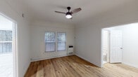 Located at 132 S Westmoreland Ave in the heart of Los Angeles, this single-floor unit offers a clean, functional layout with a welcoming, neutral aesthetic throughout. The living areas feature warm-toned hardwood-style flooring that runs continuously, adding cohesion and a sense of openness to the space. Ceiling fans with integrated lighting are present in the main rooms, providing both comfort and practical illumination. White walls throughout create a bright, airy atmosphere that allows natural light from the windows to reflect throughout the interior.

The kitchen is a standout feature, designed in a galley style with grey shaker cabinetry lining both sides, granite-look countertops, a stainless steel double sink, and a gas range with an overhead ventilation hood. White tile flooring and a window with natural light make this a clean and efficient cooking space.

The bathroom is finished entirely in white, featuring tile flooring, a shower-tub combination, a vanity with storage, and a small window for ventilation and natural light, maintaining the crisp, minimal feel of the unit.

Additional highlights include wall-mounted heating units in the main rooms and a layout that flows naturally between the living, sleeping, and kitchen areas, making the space practical and easy to navigate.