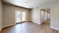 Located at 800 W Battles Rd in Santa Maria, California, this single-story, 4-bedroom, 2-bathroom home offers a functional and modern layout designed for comfortable living. The open living area features wood-look flooring and French doors that invite natural light and provide access to an outdoor space. The kitchen is a standout feature, showcasing crisp white shaker cabinetry, light granite countertops, stainless steel appliances including a refrigerator, range, microwave, and dishwasher, recessed lighting, and a deep single-basin sink — all set atop durable wood-look flooring. The four bedrooms are finished with soft neutral carpeting, windows with blinds for natural light and privacy, and clean white trim throughout. Each bedroom benefits from dedicated closet space, including walk-in and sliding-door closet configurations. The two bathrooms are efficiently designed, with one featuring a shower-tub combo and the other a standalone shower stall, both appointed with neutral tile flooring and chrome fixtures. A dedicated laundry room and a connecting hallway complete the interior layout, offering practical organization throughout the home.