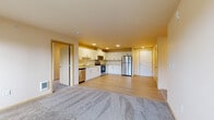 Located in Everett, WA, this well-appointed 4-bedroom, 2-bathroom unit offers a thoughtfully designed single-level layout with a generous amount of living space. The open-concept kitchen and living area serves as the heart of the home, where light hardwood-style flooring flows through the kitchen and transitions into soft carpet in the living area. The kitchen is equipped with stainless steel appliances, including a gas range, built-in microwave, dishwasher, and a full-size refrigerator, all complemented by crisp white cabinetry, ample counter space, and recessed lighting overhead.

The four bedrooms are carpeted and comfortably sized, each featuring sliding windows that frame views of the surrounding evergreen trees. The primary bedroom includes a spacious walk-in closet with wire shelving that spans multiple walls, offering exceptional storage. Two full bathrooms serve the home, with one featuring a soaking tub, white vanity cabinetry, and light hardwood-style flooring.

A dedicated laundry room houses a full-size Whirlpool front-loading washer and dryer, adding significant convenience. A hallway connects the rooms efficiently, rounding out a functional and comfortable floor plan well-suited for everyday living.