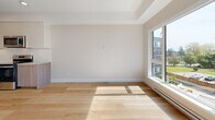 Located at 45 Gorge Rd E in Victoria, BC, this well-appointed one-bedroom, one-bathroom unit offers a thoughtfully designed layout with modern finishes throughout. Light oak hardwood flooring runs continuously across the living spaces, lending warmth and a clean, contemporary aesthetic.

The open living area is bathed in natural light through large windows that frame views of the surrounding neighbourhood. A ceiling fan adds both function and style to the space. Baseboard heating ensures year-round comfort throughout the unit.

The kitchen is equipped with stainless steel appliances — including an electric range, built-in microwave, and dishwasher — complemented by two-tone cabinetry featuring warm wood lower cabinets and crisp white uppers, all set against a bright subway tile backsplash and quartz-style countertops.

The bedroom is a well-sized, private retreat with its own window offering natural light and outdoor views. A dedicated closet provides practical storage. The bathroom features a full soaker tub with a tiled surround in a neutral stone-look finish, a wood-toned vanity with undermount sink, and clean white cabinetry. The unit also includes a private balcony, perfect for enjoying Victoria's mild climate.