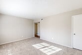 Located at 3200 Desert Dr in East Point, GA, this single-floor, 2-bedroom unit offers a functional and comfortable layout. The entry foyer features wood-look vinyl flooring that transitions into plush carpeting throughout the living and bedroom areas, creating a warm, cohesive feel.

The generously sized primary bedroom offers ample square footage, with natural light streaming in through windows fitted with blinds, and direct access to a dedicated walk-in closet complete with built-in shelving and hanging rods. The second bedroom is a comfortable, well-proportioned room with carpet flooring and good natural light.

The kitchen is a standout feature, equipped with stainless steel appliances including a gas range, dishwasher, and full-size refrigerator. White shaker-style cabinetry, granite-look countertops, a subway tile backsplash, and wood-look vinyl flooring give the kitchen a modern, clean aesthetic. A range hood and ceiling light fixture complete the space.

Throughout the unit, neutral warm-beige walls, white trim, and consistent finishes create a bright and move-in-ready atmosphere. The layout is efficient yet open, offering comfortable living across all rooms. Centrally located in East Point, this unit provides convenient access to the greater Atlanta metropolitan area.