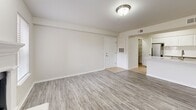 Located at 1551 W 78th St S in Tulsa, Oklahoma, this single-floor, one-bedroom, three-bathroom unit offers a thoughtfully designed layout that maximizes its compact footprint. The living room serves as the heart of the home, featuring light gray wood-style flooring, a classic white-mantled fireplace flanked by two windows that invite natural light, and neutral walls that create a bright, open atmosphere. Adjacent to the living area is a well-equipped kitchen outfitted with white raised-panel cabinetry, a white subway tile backsplash, light countertops, tile flooring, and stainless steel appliances including a refrigerator, range, and over-the-range microwave. A nearby hallway area with tile flooring provides convenient access to a dedicated laundry space complete with washer/dryer hookups and an electrical panel. The generously sized bedroom features plush carpeting, a ceiling fan with light fixture, and a window overlooking greenery. The primary bathroom includes a tiled tub/shower combo, a wide vanity with white countertops, and tile flooring. Two closets provide ample storage throughout. The unit's clean, neutral palette and consistent finishes lend a cohesive, move-in-ready feel throughout.