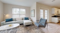 Located at 243 Talcottville Rd in Vernon Rockville, Connecticut, this single-floor residence offers a thoughtfully designed layout that balances functionality and modern aesthetics. Light-toned hardwood flooring runs consistently throughout the space, lending a cohesive and airy feel to every room.

The kitchen is a standout feature, showcasing white shaker-style cabinetry with brushed nickel hardware, granite countertops, and a full suite of stainless steel appliances including a refrigerator, range, dishwasher, and built-in microwave. A peninsula with pendant lighting provides additional prep space and casual seating, while recessed lighting illuminates the area efficiently.

The living room benefits from large windows that invite generous natural light, along with a glass-panel entry door that further brightens the space. The open layout connects the living and kitchen areas seamlessly, supporting a comfortable flow throughout.

The bedroom features light wood flooring, a dedicated closet, and a wide window offering outdoor views. The full bathroom includes a dark-finish vanity with a white countertop, a mirrored medicine cabinet, a tub-shower combination, and coordinating light wood flooring, completing the unit with a clean, contemporary finish.