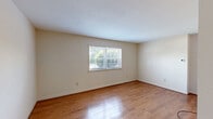 Located at 86 Summercrest Ave in Waynesboro, Virginia, this two-bedroom, one-bathroom single-floor home offers a well-organized and functional layout. Warm hardwood flooring flows throughout the living areas and bedrooms, contributing to a cohesive and inviting atmosphere. The living room features a slatted partition dividing it from the adjacent dining area, which is accented by a classic brass chandelier and tile flooring. Natural light streams into multiple rooms through large windows with blinds, offering views of the surrounding greenery. The kitchen is fitted with rich wood cabinetry, a white range, tile backsplash, and a full-height pantry cabinet, providing ample storage and counter space. The primary bedroom is generously sized and includes a louvered bi-fold closet, while the second bedroom also benefits from natural light and hardwood floors. With four closets distributed throughout the home, storage is plentiful. The bathroom features a full tub and shower combo with white tile surround. This compact yet well-appointed home presents a practical and comfortable living space in a residential Waynesboro neighborhood.