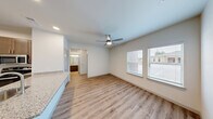 Located at 10420 Hartsook Street in Houston, TX, this single-story, one-bedroom, one-bathroom unit offers a well-designed layout that maximizes every inch of its compact footprint. The open-concept living and kitchen area forms the heart of the home, where light wood-style flooring flows seamlessly throughout and a ceiling fan keeps the space comfortable. Natural light filters in through slatted windows, brightening the living area.

The kitchen is a standout feature, anchored by a granite-topped peninsula with an undermount sink and dishwasher, ideal for both food prep and casual dining. Dark-toned cabinetry provides ample storage and contrasts elegantly with the granite surfaces. Stainless steel appliances — including a refrigerator, range, and microwave — complete the modern kitchen suite. A pantry provides additional storage just steps away.

The bedroom offers a quiet retreat with a ceiling fan and access to a dedicated closet. The bathroom continues the cohesive design with granite countertops, dark wood cabinetry, and the same warm wood-style flooring. In-unit laundry adds everyday convenience. Clean white walls, recessed lighting, and consistent finishes throughout give this unit a fresh, modern, and move-in-ready appeal.