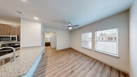 Located at 10420 Hartsook Street in Houston, TX, this single-story, one-bedroom, one-bathroom unit offers a well-designed layout that maximizes every inch of its compact footprint. The open-concept living and kitchen area forms the heart of the home, where light wood-style flooring flows seamlessly throughout and a ceiling fan keeps the space comfortable. Natural light filters in through slatted windows, brightening the living area.

The kitchen is a standout feature, anchored by a granite-topped peninsula with an undermount sink and dishwasher, ideal for both food prep and casual dining. Dark-toned cabinetry provides ample storage and contrasts elegantly with the granite surfaces. Stainless steel appliances — including a refrigerator, range, and microwave — complete the modern kitchen suite. A pantry provides additional storage just steps away.

The bedroom offers a quiet retreat with a ceiling fan and access to a dedicated closet. The bathroom continues the cohesive design with granite countertops, dark wood cabinetry, and the same warm wood-style flooring. In-unit laundry adds everyday convenience. Clean white walls, recessed lighting, and consistent finishes throughout give this unit a fresh, modern, and move-in-ready appeal.