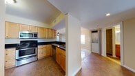 Located at 800 The Pointe Dr in West Palm Beach, Florida, this single-floor residence offers a well-designed layout with a practical and comfortable flow throughout. The kitchen is thoughtfully equipped with warm maple cabinetry, dark granite countertops, stainless steel appliances including a double oven, built-in microwave, and dishwasher, all set atop neutral tile flooring. A half-wall partition separates the kitchen from the rest of the living space, adding definition while maintaining an open feel. The main living and dining areas feature gleaming large-format tile flooring and ceiling fans with light fixtures, creating a bright and airy atmosphere. Sliding glass doors invite natural light and provide outdoor views, enhancing the sense of space. An in-unit stacked washer and dryer is conveniently accessible from the main living corridor. The primary bathroom showcases a striking blue vanity with granite countertops, a decorative framed mirror, and updated brushed nickel fixtures. A secondary full bathroom includes a tiled tub-surround with a built-in niche and warm wood cabinetry. Bedrooms are finished with tile flooring, ceiling fans, and windows that bring in natural light. The unit also includes a separate water closet for added privacy.