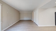 Located at 5816 Westpark Drive in Charlotte, NC, this efficiently designed single-floor unit offers a thoughtful layout that maximizes every square foot. Light-toned luxury vinyl plank flooring runs throughout, lending a clean, cohesive look to the entire space.

The open living area is bright and welcoming, featuring neutral warm-beige walls, white trim, and a textured ceiling. A sliding glass door floods the room with natural light and opens directly onto a private balcony, providing outdoor views and excellent ventilation.

The kitchen is well-appointed with white shaker-style cabinetry, granite countertops, and a full suite of appliances including a stainless steel electric range, dishwasher, black refrigerator, and over-the-range microwave. Recessed lighting and under-cabinet lighting enhance both functionality and ambiance.

A dedicated entrance provides a clear transition into the living space, while a louvered bi-fold closet door near the bathroom area offers practical storage. The bathroom includes granite countertops consistent with the kitchen's finishes, maintaining a unified aesthetic throughout the unit.

Overall, the space presents a clean, modern, and move-in-ready interior, ideal for those seeking a functional and stylish residence in the Charlotte area.