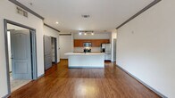 Located at 4400 SW 20th Ave in Gainesville, FL, this single-floor, 2-bedroom, 2-bathroom residence offers a thoughtfully designed layout with a comfortable and functional living environment. The open-concept kitchen serves as the heart of the home, featuring warm wood cabinetry, stainless steel appliances including a range, microwave, and refrigerator, and a large central island with a white countertop and built-in sink — ideal for both meal preparation and casual dining. Track lighting illuminates the kitchen and adjoining living area, which is finished with rich hardwood-style flooring throughout. The primary bedroom is a spacious retreat with a ceiling fan, crown molding accents, and French doors that open to an outdoor view, providing natural light and a seamless indoor-outdoor connection. The second bedroom also features a ceiling fan, carpeted flooring, and a window overlooking the surrounding greenery. Both bathrooms are finished with tile flooring and warm wood vanities topped with granite-style countertops. One bathroom includes a walk-in shower, while the other offers a tub and shower combination. Additional features include two closets — one of which is a walk-in — a hallway connecting the main living areas, and a well-organized overall floor plan that maximizes the available space.