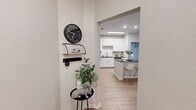 Located in Tampa, FL, this single-story 2-bedroom, 2-bathroom residence offers a thoughtfully designed layout with modern finishes throughout. Light wood-tone flooring flows seamlessly across the main living areas, complementing the bright, neutral color palette.

The kitchen is a standout feature, boasting white shaker cabinetry, a classic subway tile backsplash, dark granite countertops, and a full suite of stainless steel appliances. A central island with seating provides additional prep space and a casual dining option.

The living room is bright and welcoming, anchored by a sliding glass door that opens to a private balcony overlooking mature trees — filling the space with natural light and outdoor views. Ceiling fans are present in key rooms for added comfort.

The primary bedroom is a comfortable retreat with multiple windows, a ceiling fan, and access to a private en-suite bathroom featuring granite countertops, white cabinetry, and a shower/tub combination. A walk-in closet with built-in shelving adds practical storage. The second bedroom and bathroom mirror the same clean, modern aesthetic. Two additional closets and multiple hallways contribute to the home's well-organized, functional flow throughout.