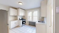 This 590 square foot apartment, located at 11 Courtland St in Paterson, NJ, offers a efficiently designed living space on a single floor. The property features two bedrooms, including a primary bedroom of 160 square feet, and one bathroom. The combined dining room and kitchen area serves as the heart of the home, boasting crisp white cabinetry, granite countertops, and stainless steel appliances. Large windows throughout provide abundant natural light, enhancing the sense of space.

The apartment showcases a blend of modern and classic elements, with newly installed light-toned wood-look flooring in the bedrooms and living areas, contrasting nicely with the white tile in the kitchen and bathroom. Vintage cast iron radiators add character while providing warmth. The bathroom features a full-size tub with modern fixtures and neutral-toned tiling.

Each room is painted in soft, neutral colors, creating a bright and airy atmosphere. The property's layout, visible in the 3D floor plan, demonstrates an efficient use of space, making it an ideal choice for those seeking a cozy yet functional urban dwelling. The exterior entrance includes a small porch, adding a touch of charm to this city apartment.