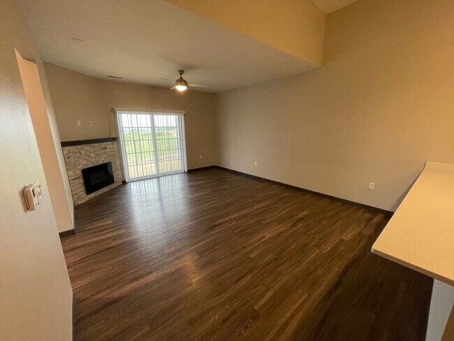 Living room with vaulted ceilings and electric fireplace - 2869 Spring Rose Cir