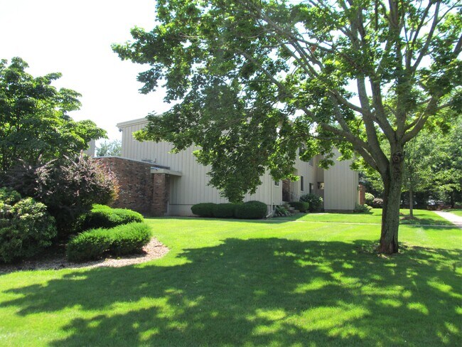 Side view of the building with well-maintained grounds - 22 Webster Ct
