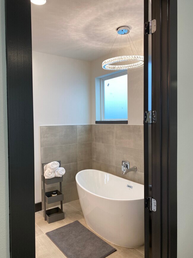 Master bathroom with freestanding tub and standing shower - 1404 Goliad St