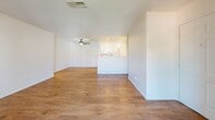 Located at 6701 Del Rey Ave in Las Vegas, NV, this two-bedroom, two-bathroom residence offers a well-organized single-level layout with a clean, neutral aesthetic throughout. The combined kitchen and living area forms the heart of the home, where warm wood-style flooring flows seamlessly underfoot. The living room is highlighted by a classic white-mantled fireplace and a sliding glass door that opens to a private balcony, allowing natural light to fill the space. A ceiling fan overhead adds functional comfort to the room.

The kitchen is bright and efficiently designed in a galley configuration, featuring white cabinetry, recessed lighting, white appliances, and a peninsula with a sink that connects to the living area — ideal for everyday functionality. Both bedrooms continue the wood-style flooring and are finished with crisp white walls and textured ceilings. The primary bedroom offers a generous footprint with its own closet, while the second bedroom provides comfortable accommodations with a nearby closet as well.

Each of the two bathrooms is clean and simply appointed, featuring tub-shower combinations with white tile surrounds and chrome fixtures. The overall palette of white walls, light flooring, and neutral finishes gives the entire residence a bright, move-in-ready feel.