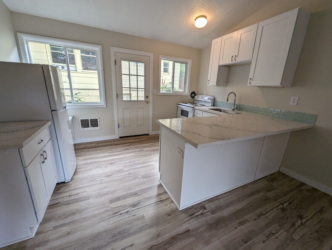 Kitchen with new cabinets, sink, appliances and quartz counter with eating bar - 5442 -5448 SE Franklin St