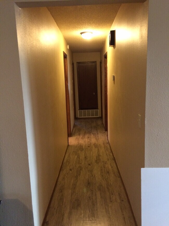 Hall to bathroom and bedrooms. - 4444 Ridgecrest Cir