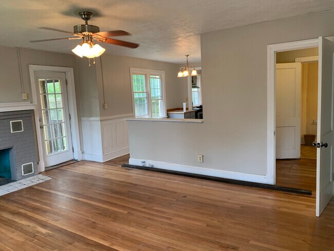 Living room with door to screened porch. - 1305 W Broadway